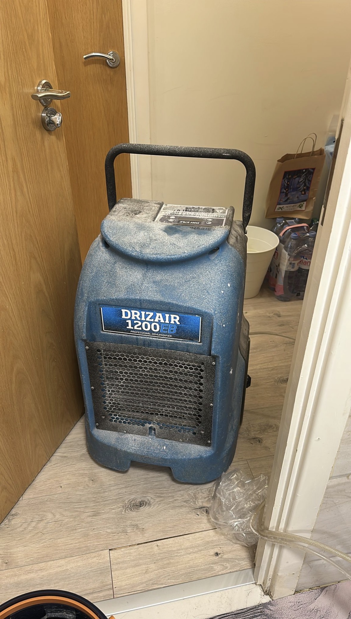 Blue professional refrigerant dehumidifier used for structural drying — front view